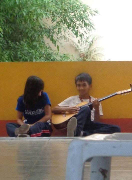 Christian playing guitar beside Alarise