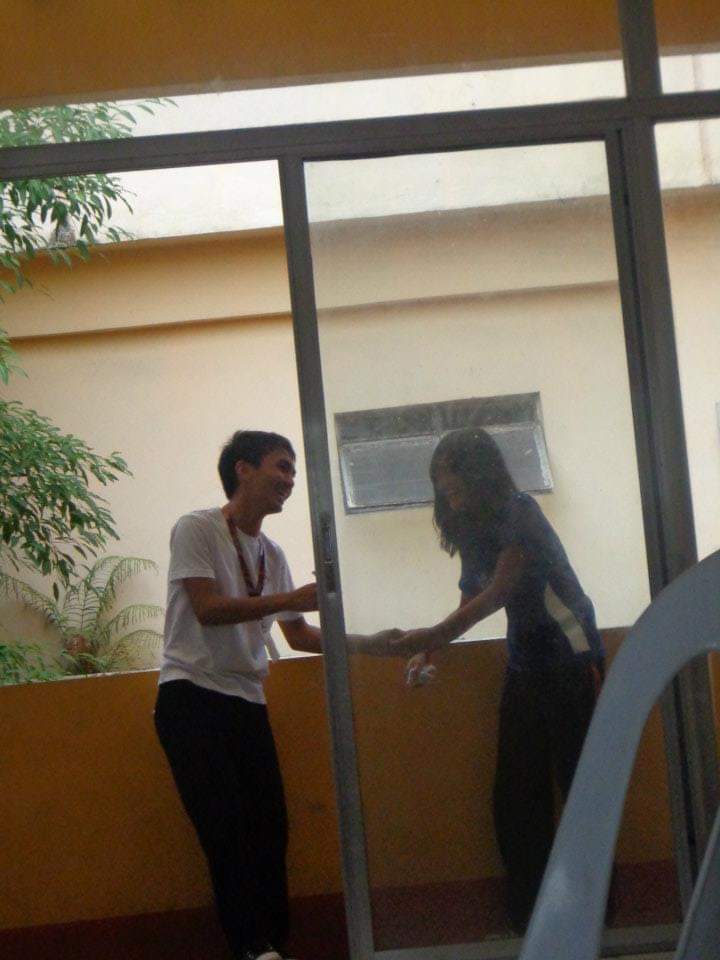 Christian and Alarise outside a glass door